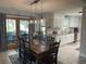 Open dining area with modern light fixtures and view into updated kitchen and deck at 312 Trace Run, Myrtle Beach, SC 29588