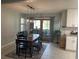 Dining room with view onto deck, modern light fixtures, and wood table at 312 Trace Run, Myrtle Beach, SC 29588