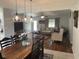 Dining area showcasing modern light fixtures and flow into living room at 312 Trace Run, Myrtle Beach, SC 29588