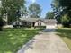 Charming single story home with well manicured lawn and red shutters on a sunny day at 312 Trace Run, Myrtle Beach, SC 29588