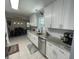 Updated kitchen featuring white cabinets, stainless steel appliances, and dining area view at 312 Trace Run, Myrtle Beach, SC 29588
