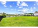 A lush green backyard slopes gently down to a scenic pond, creating a private outdoor retreat at 317 Truce St., Myrtle Beach, SC 29588