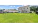 Expansive backyard featuring lush green grass, black fence, and an inviting outdoor space for recreation at 317 Truce St., Myrtle Beach, SC 29588
