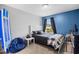 Cozy bedroom featuring a blue accent wall, natural light, and comfortable furnishings at 317 Truce St., Myrtle Beach, SC 29588