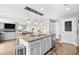 Open-concept kitchen featuring granite counters, an island with a sink, and seamless flow to living and dining areas at 317 Truce St., Myrtle Beach, SC 29588