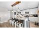 Bright kitchen with white cabinetry, stainless appliances, granite countertops, and central island with barstool seating at 317 Truce St., Myrtle Beach, SC 29588