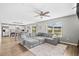 Spacious living room with a comfortable gray sectional sofa, ceiling fan, and large windows at 317 Truce St., Myrtle Beach, SC 29588