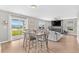 Open-concept dining and living space with views of the lake through the glass sliding door at 317 Truce St., Myrtle Beach, SC 29588