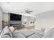 Comfortable living room with gray sectional sofa, fireplace, large television, ceiling fan, and wood-look flooring at 317 Truce St., Myrtle Beach, SC 29588