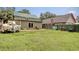 View of backyard with a boat, lawn, and guest house with light green metal roof at 325 Orange St., Georgetown, SC 29440