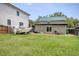 View of the backyard with boat, lawn, and guest house with light green metal roof at 325 Orange St., Georgetown, SC 29440