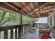 Balcony overlooking green trees with wooden floors and wooden chairs at 325 Orange St., Georgetown, SC 29440