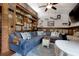 Comfortable living room featuring an expansive sofa, custom shelving, and views of the backyard at 325 Orange St., Georgetown, SC 29440