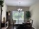 Bright dining room featuring a grand grandfather clock, a chandelier, and a view to the outdoors at 340 Barony Dr., Conway, SC 29526