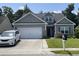 Charming single-Gathering home with a well-maintained front lawn and attached two-car garage at 340 Barony Dr., Conway, SC 29526