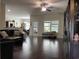 Open-concept living area featuring dark hardwood floors and seamless flow to the dining area at 340 Barony Dr., Conway, SC 29526