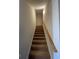 Carpeted stairs lead to the upper level of the home, with a wooden handrail at 340 Barony Dr., Conway, SC 29526