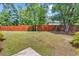Back yard with a wood fence, green grass, landscaping, and an area to display outdoor decor at 3864 Journeys End Rd., Murrells Inlet, SC 29576