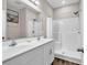 Bathroom featuring a double sink vanity, large mirror, and walk-in shower at 3864 Journeys End Rd., Murrells Inlet, SC 29576