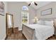 Cozy bedroom featuring a white-washed bed frame, a large window, and a decorative gold mirror at 3864 Journeys End Rd., Murrells Inlet, SC 29576