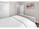 Neutral bedroom featuring clean white bedding, an accent painting, and a closet with bi-fold doors at 3864 Journeys End Rd., Murrells Inlet, SC 29576