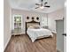 Bedroom with a tray ceiling, ceiling fan, bedside tables and lamps and large bed at 3864 Journeys End Rd., Murrells Inlet, SC 29576