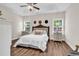 Bedroom with a tray ceiling, ceiling fan, bedside tables and lamps and large bed at 3864 Journeys End Rd., Murrells Inlet, SC 29576