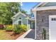 Charming home exterior featuring stone accents, manicured landscaping, and a blue-grey paint scheme at 3864 Journeys End Rd., Murrells Inlet, SC 29576