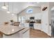 Modern kitchen with white cabinetry, granite countertops, and stainless steel appliances under vaulted ceilings at 3864 Journeys End Rd., Murrells Inlet, SC 29576