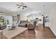 Inviting living room featuring vaulted ceilings, sliding glass door, ceiling fan, and a view into the kitchen at 3864 Journeys End Rd., Murrells Inlet, SC 29576