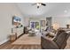 Bright living room with vaulted ceilings, sliding glass door, ceiling fan, and warm wood-look flooring at 3864 Journeys End Rd., Murrells Inlet, SC 29576