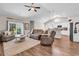 Inviting living room featuring vaulted ceilings, wood floors, and a sliding door for outdoor access at 3864 Journeys End Rd., Murrells Inlet, SC 29576
