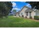 Well-maintained backyard featuring a pergola covered patio and lush green lawn at 3888 Stillwood Dr., Myrtle Beach, SC 29588