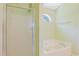 Bathroom with glass-enclosed shower, soaking tub and half-moon window providing natural light at 3888 Stillwood Dr., Myrtle Beach, SC 29588