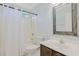 Bathroom with tub and shower combination, dark wood vanity with white sink, and large mirror at 3888 Stillwood Dr., Myrtle Beach, SC 29588