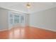 Bright bedroom features hardwood floors, a ceiling fan, and a bay window with natural light at 3888 Stillwood Dr., Myrtle Beach, SC 29588