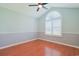 Bedroom with vaulted ceiling, ceiling fan, half-moon window, two-toned paint, and wood laminate floor at 3888 Stillwood Dr., Myrtle Beach, SC 29588