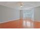 Open bedroom with hardwood floors, large bay windows, a ceiling fan, and neutral paint at 3888 Stillwood Dr., Myrtle Beach, SC 29588