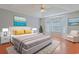 Well-lit bedroom with hardwood floors, tray ceiling, bay window, and elegant neutral decor at 3888 Stillwood Dr., Myrtle Beach, SC 29588