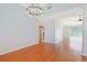 Open dining room showcasing hardwood floors, modern lighting, and easy access to the kitchen and backyard at 3888 Stillwood Dr., Myrtle Beach, SC 29588