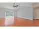 Living room featuring wood floors, bright windows, a ceiling fan, and access to the backyard at 3888 Stillwood Dr., Myrtle Beach, SC 29588