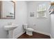 Modern powder room with pedestal sink, wood-look floors, and natural light at 405 Spring View Ct., Little River, SC 29566