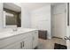 Bathroom features a large mirror over sink, tiled floors, and a view of the tiled shower at 405 Spring View Ct., Little River, SC 29566