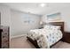 Relaxing bedroom with neutral tones showcasing a bed with nautical-themed bedding and matching wooden furnishings at 405 Spring View Ct., Little River, SC 29566