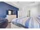 Comfortable bedroom with striped bedding, flat-screen TV, and a cozy beanbag chair at 405 Spring View Ct., Little River, SC 29566