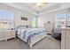 Bright bedroom with a queen-sized bed, natural light, and light color furniture at 405 Spring View Ct., Little River, SC 29566