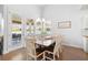 Dining room with hardwood floors, large windows, and dining table with 8 chairs at 405 Spring View Ct., Little River, SC 29566