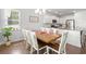 Bright dining room with dark hardwood floors, modern chandelier, and a kitchen view at 405 Spring View Ct., Little River, SC 29566