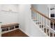 Inviting entryway featuring built-in storage bench with shoe racks and a staircase at 405 Spring View Ct., Little River, SC 29566