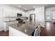 White kitchen featuring a large island with seating, stainless steel appliances and gorgeous countertops at 405 Spring View Ct., Little River, SC 29566